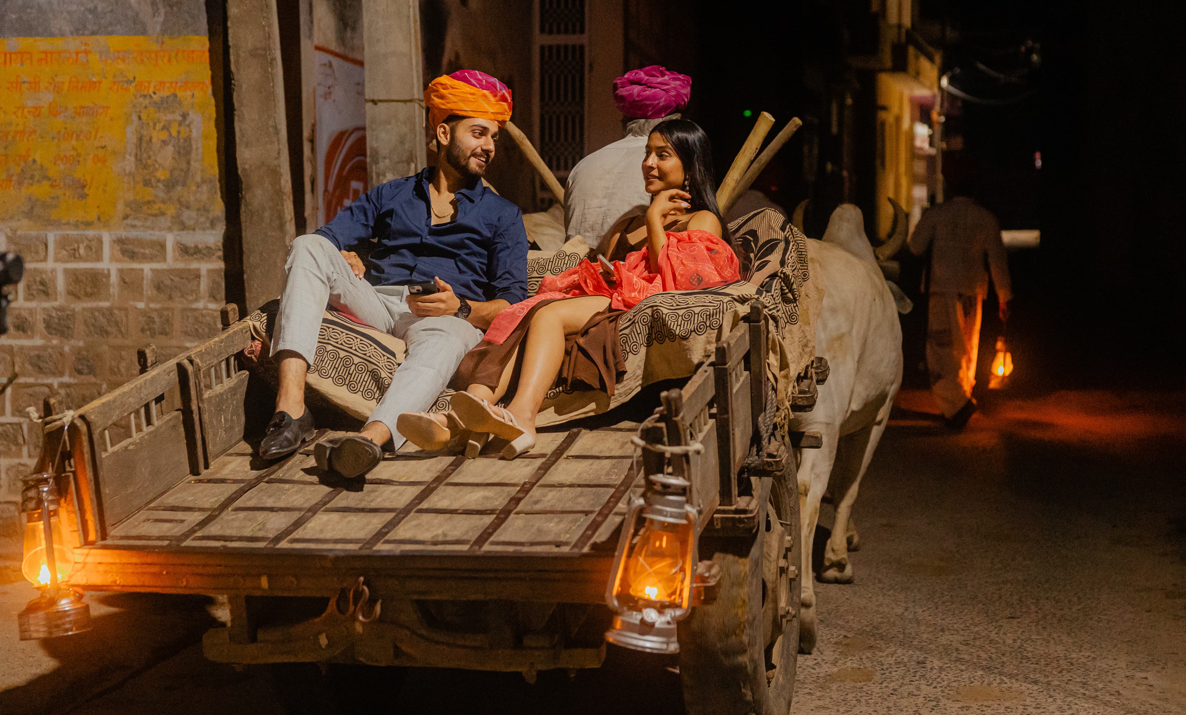 Couple on camel carriage.